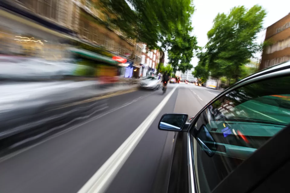 Blurry speeding cars on an urban road